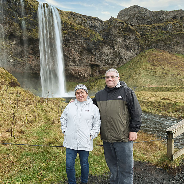 Rosalie and Andy Pion in front of a waterfall