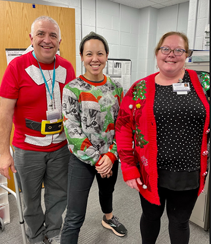 Staff in holiday sweaters