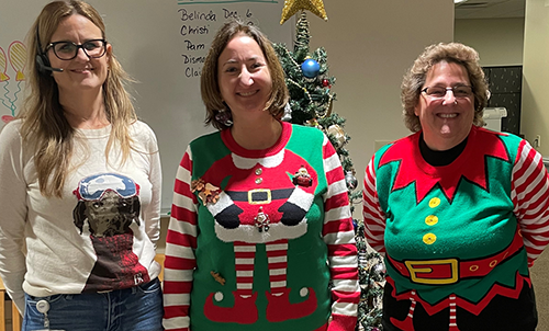 Staff in holiday sweaters
